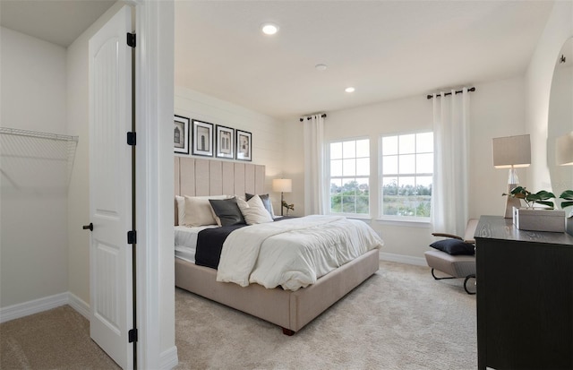 bedroom with recessed lighting, baseboards, and light colored carpet