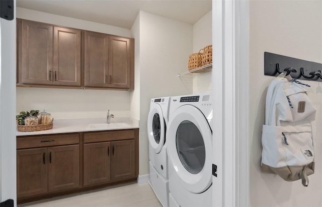 laundry area featuring washing machine and dryer and a sink