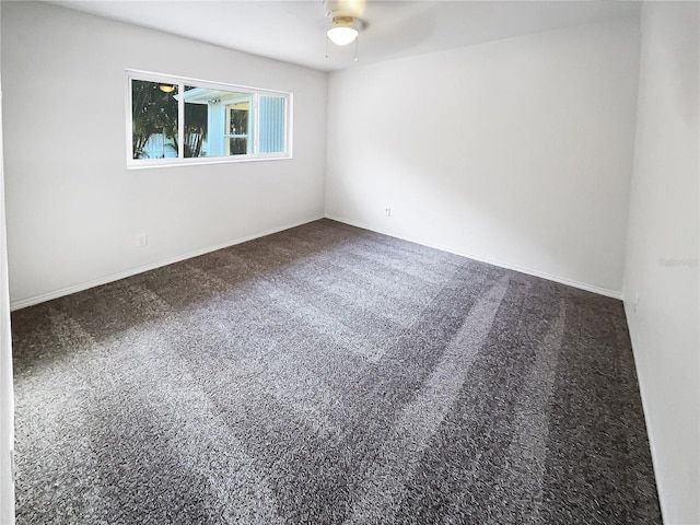 unfurnished room with carpet, baseboards, and a ceiling fan