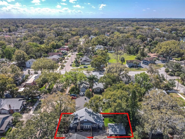 aerial view featuring a forest view and a residential view