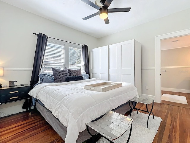 bedroom featuring dark wood finished floors, baseboards, and ceiling fan