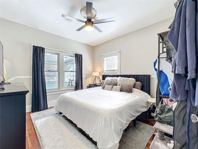 bedroom with baseboards, a ceiling fan, and wood finished floors