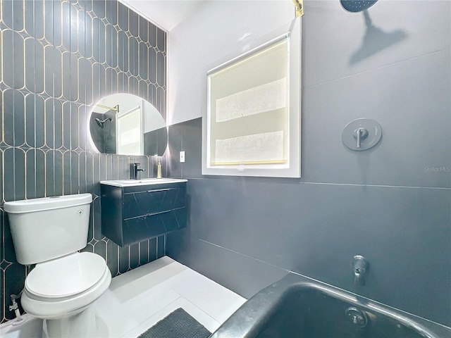 bathroom with toilet, a washtub, vanity, tile walls, and a shower