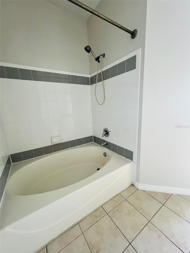 full bath featuring baseboards, shower / tub combination, and tile patterned floors