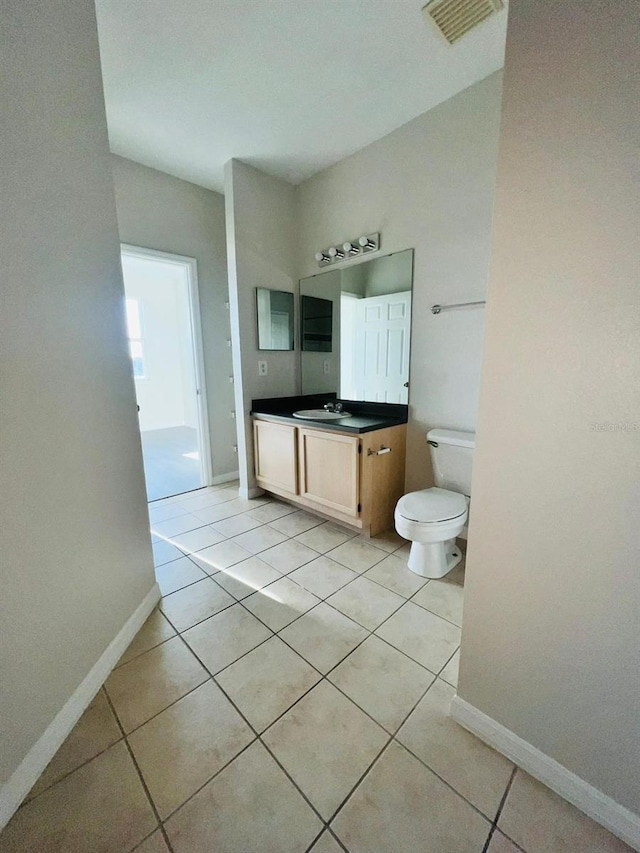 bathroom with baseboards, visible vents, toilet, tile patterned floors, and vanity