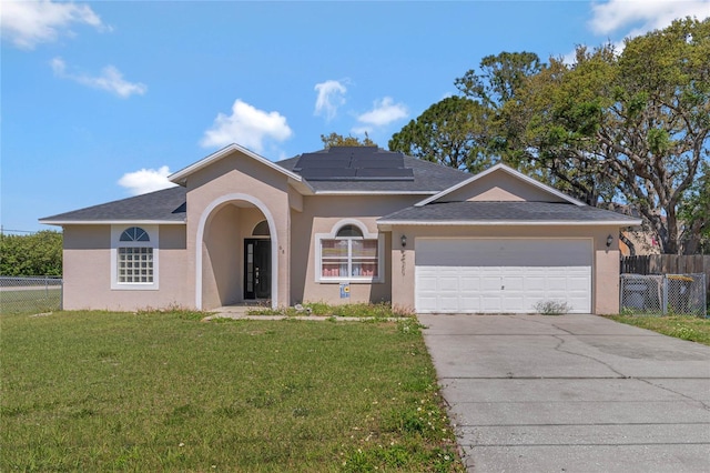 68 Herring Ct, Kissimmee, FL 34759 - single story home with a front yard, driveway, solar panels, stucco siding, and a garage