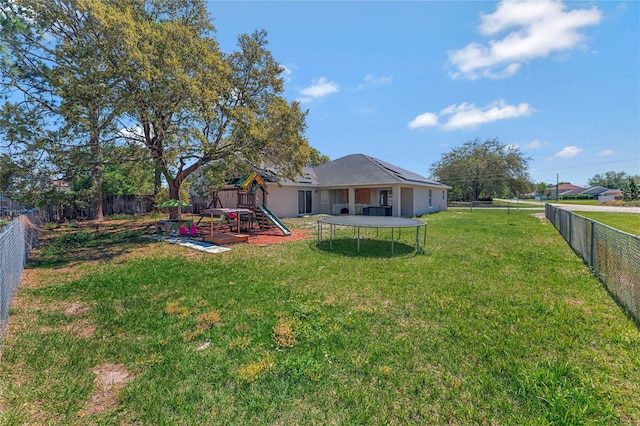 68 Herring Ct, Kissimmee, FL 34759 - view of yard featuring a trampoline, a fenced backyard, and a playground