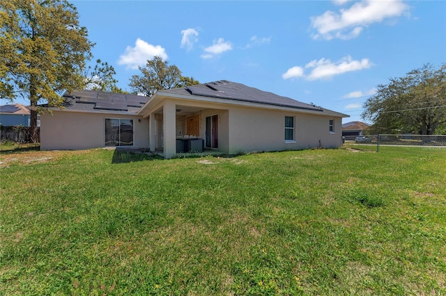 68 Herring Ct, Kissimmee, FL 34759 - back of property featuring stucco siding, a yard, and a fenced backyard