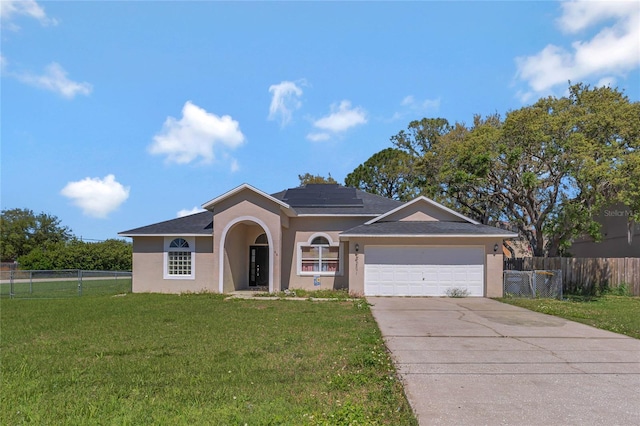 68 Herring Ct, Kissimmee, FL 34759 - ranch-style house with a front lawn, fence, stucco siding, a garage, and driveway