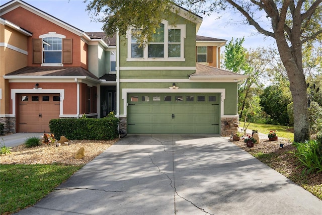 view of front of house with a garage, stone siding, and stucco siding