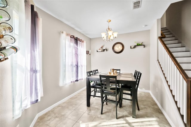 dining space featuring a notable chandelier, visible vents, stairway, light tile patterned flooring, and baseboards