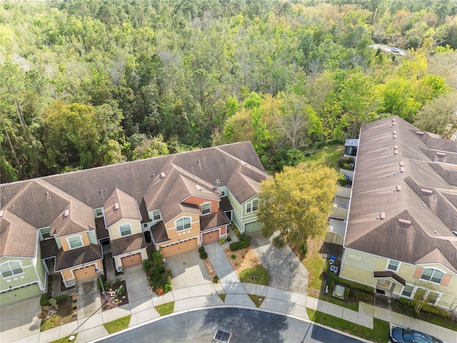 bird's eye view featuring a forest view and a residential view