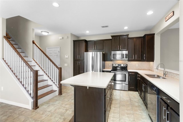 2015 Shalimar Loop, Sanford, FL 32773 - kitchen featuring appliances with stainless steel finishes, a sink, light countertops, dark brown cabinets, and backsplash
