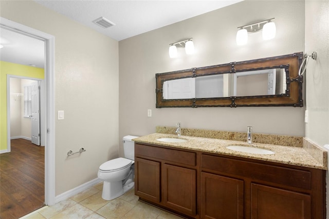 2015 Shalimar Loop, Sanford, FL 32773 - bathroom with double vanity, toilet, and baseboards