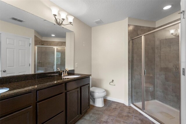 2015 Shalimar Loop, Sanford, FL 32773 - full bath featuring toilet, double vanity, a shower stall, baseboards, and a textured ceiling