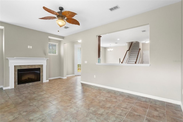 2015 Shalimar Loop, Sanford, FL 32773 - unfurnished living room featuring ceiling fan, a tile fireplace, a chandelier, and stairs