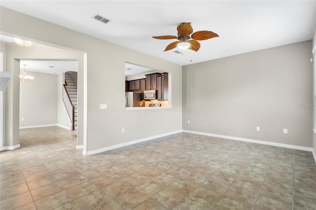 2015 Shalimar Loop, Sanford, FL 32773 - unfurnished living room with ceiling fan, stairway, a chandelier, and stone finish floors