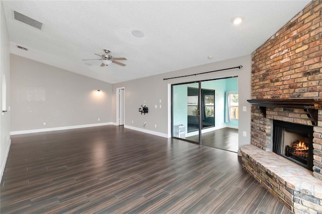 unfurnished living room featuring baseboards, a fireplace, visible vents, and a ceiling fan