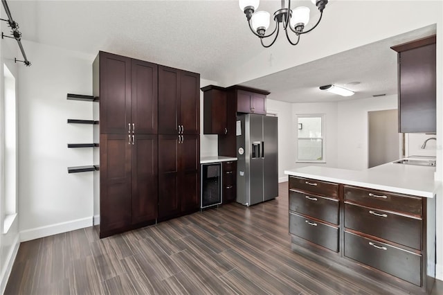 kitchen with dark wood finished floors, wine cooler, light countertops, stainless steel refrigerator with ice dispenser, and a sink