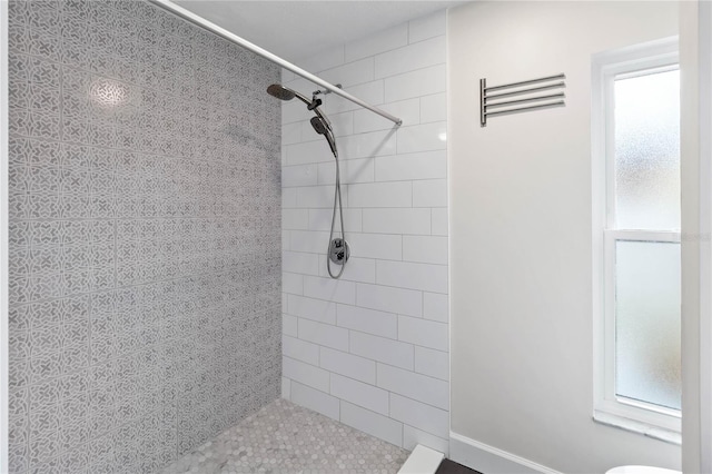 bathroom with a tile shower