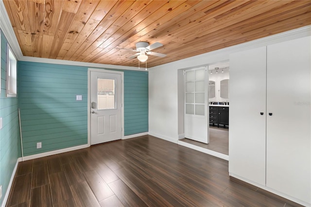 entrance foyer featuring baseboards, dark wood finished floors, a ceiling fan, wood ceiling, and crown molding