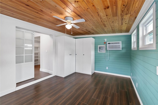 unfurnished bedroom featuring an AC wall unit, wooden ceiling, dark wood finished floors, and baseboards