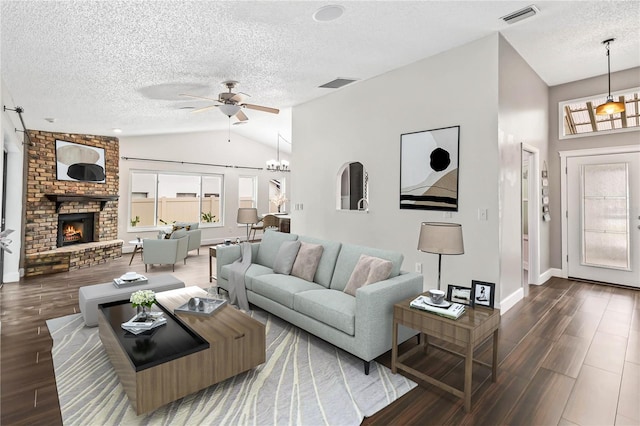 living area with plenty of natural light, a fireplace, visible vents, and dark wood-type flooring