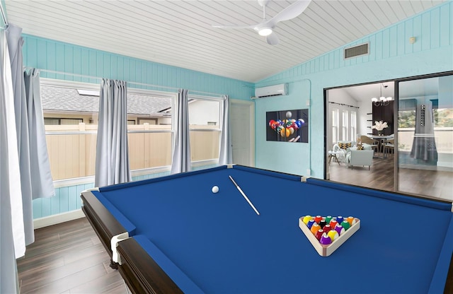 playroom with lofted ceiling, visible vents, wood finished floors, a wall mounted air conditioner, and ceiling fan with notable chandelier