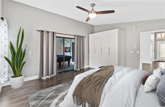 bedroom featuring ceiling fan, baseboards, vaulted ceiling, and wood finished floors