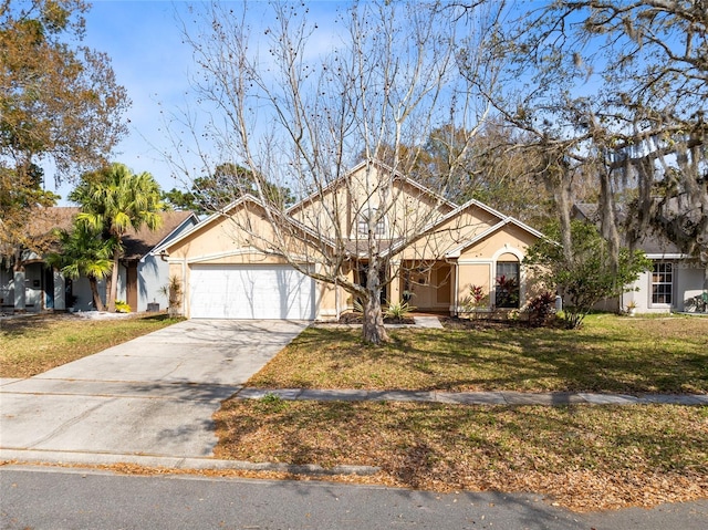 view of front of house with a garage, driveway, a front yard, and stucco siding