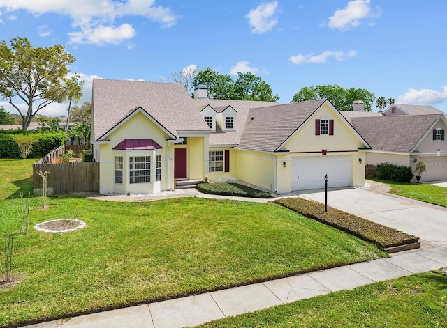 view of front facade featuring a garage, fence, concrete driveway, and a front yard