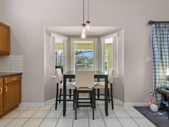 dining room with baseboards and light tile patterned floors