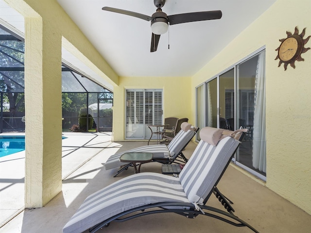 view of patio with ceiling fan, a lanai, and a fenced in pool