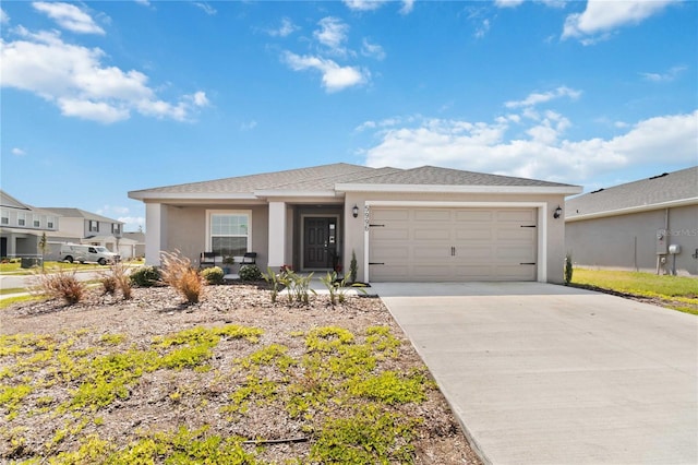 view of front of house with a garage, concrete driveway, a shingled roof, and stucco siding