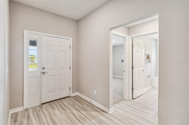 foyer featuring light wood-type flooring and baseboards