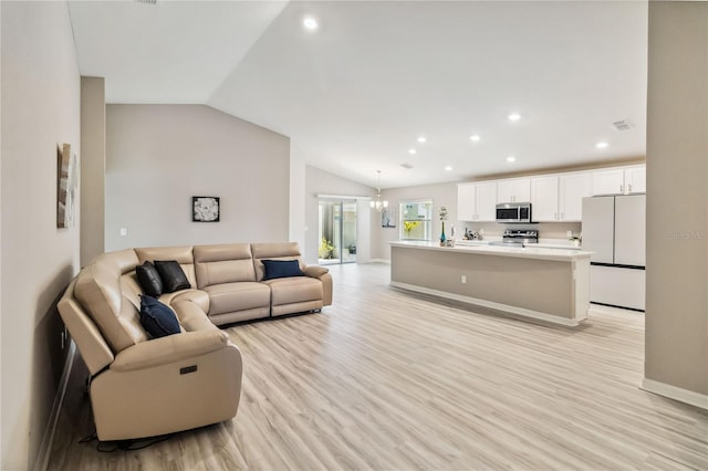 living room featuring a notable chandelier, light wood finished floors, lofted ceiling, recessed lighting, and baseboards