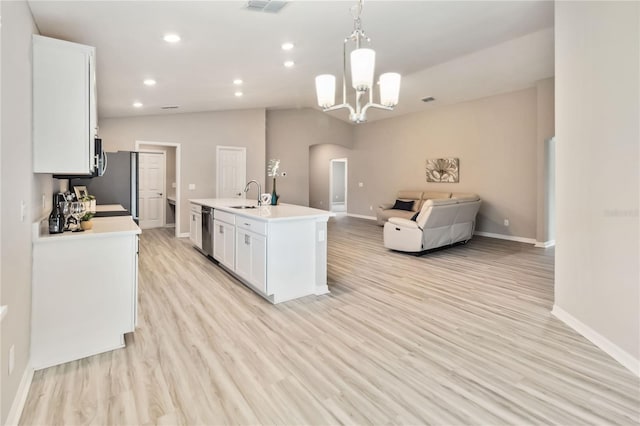 kitchen with arched walkways, lofted ceiling, a sink, white cabinets, and dishwasher