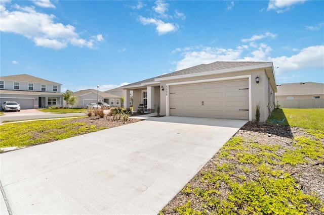 view of front of home with a garage, a residential view, driveway, and stucco siding