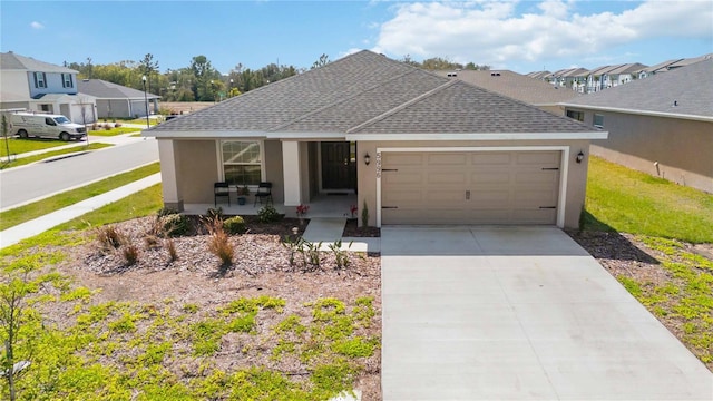 ranch-style house with a garage, covered porch, a shingled roof, concrete driveway, and stucco siding