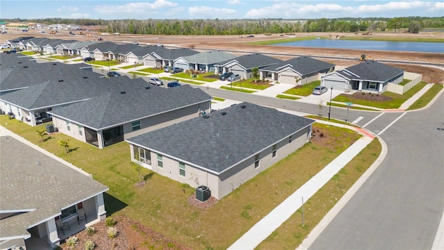 drone / aerial view with a residential view and a water view