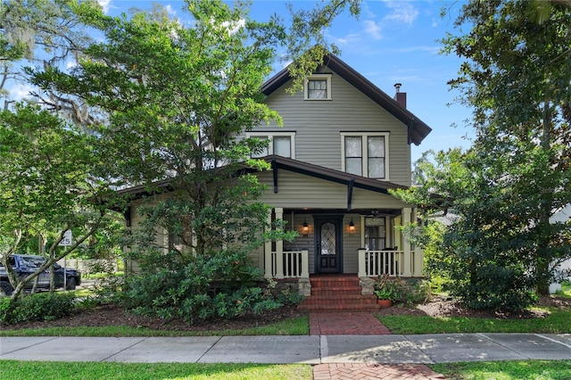 view of front of property featuring a porch and a chimney