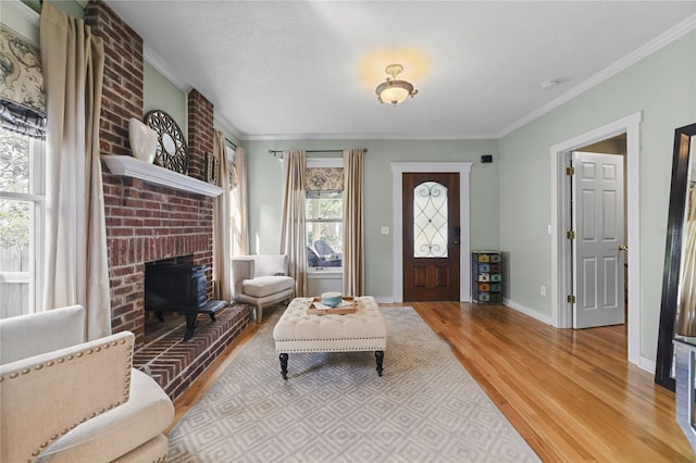 foyer entrance featuring baseboards, crown molding, and light wood finished floors