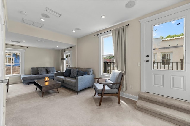 living room featuring light carpet, baseboards, visible vents, and recessed lighting