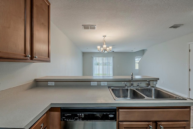 kitchen featuring dishwasher, brown cabinets, visible vents, and a sink