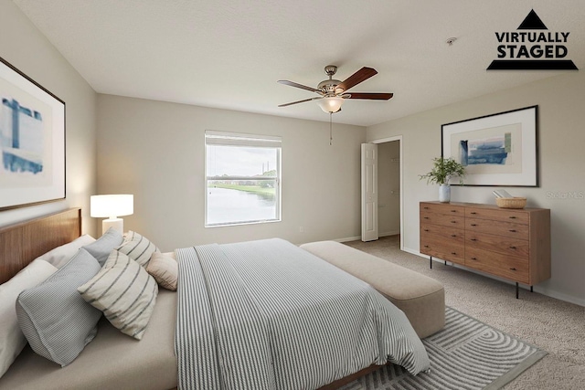 carpeted bedroom featuring baseboards and ceiling fan