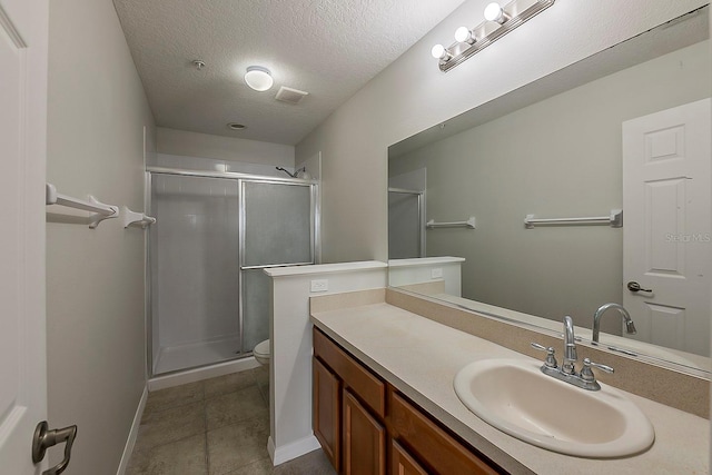 full bathroom featuring visible vents, toilet, a stall shower, a textured ceiling, and vanity