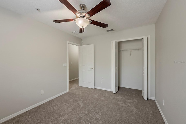 unfurnished bedroom with carpet, baseboards, visible vents, and a closet