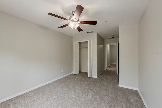 unfurnished bedroom featuring visible vents, a ceiling fan, a closet, carpet floors, and baseboards