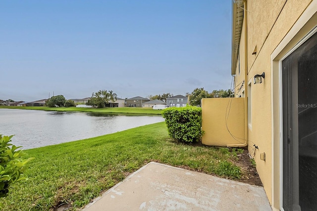 view of yard with a residential view and a water view