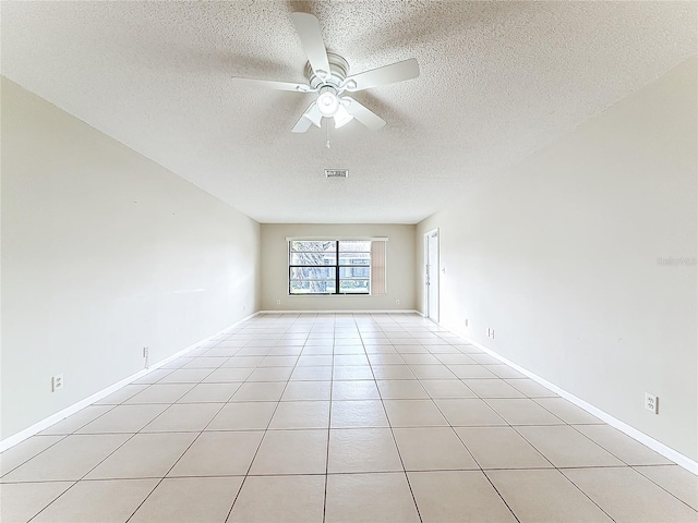 unfurnished room featuring visible vents, baseboards, ceiling fan, a textured ceiling, and light tile patterned flooring